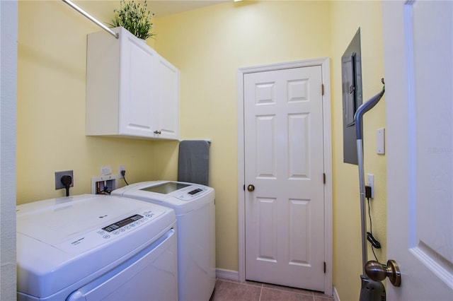 laundry area with cabinets, light tile patterned floors, and washer and clothes dryer