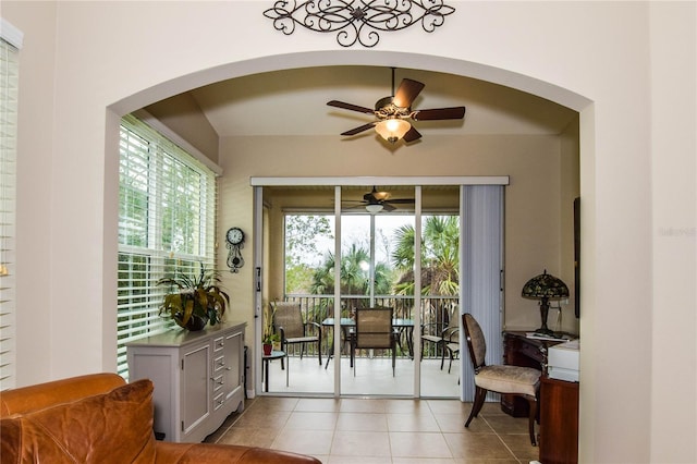 interior space with light tile patterned floors and ceiling fan