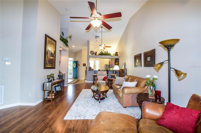 living room with high vaulted ceiling, ceiling fan, and dark wood-type flooring