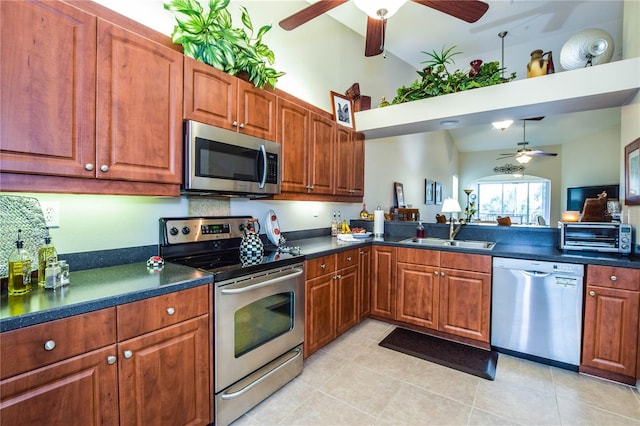 kitchen featuring stainless steel appliances, ceiling fan, sink, light tile patterned floors, and lofted ceiling