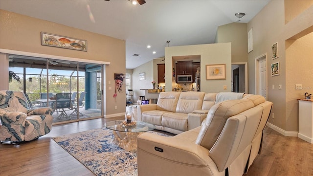 living room featuring high vaulted ceiling, ceiling fan, and light hardwood / wood-style floors