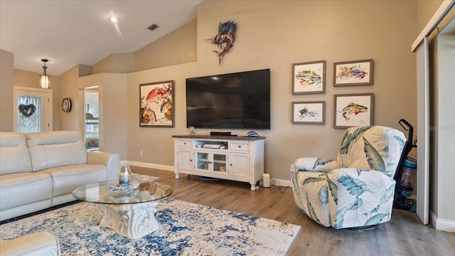 living room featuring hardwood / wood-style floors and vaulted ceiling