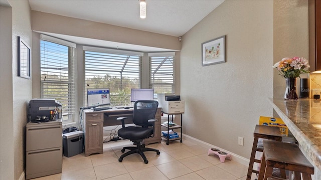 tiled home office with vaulted ceiling