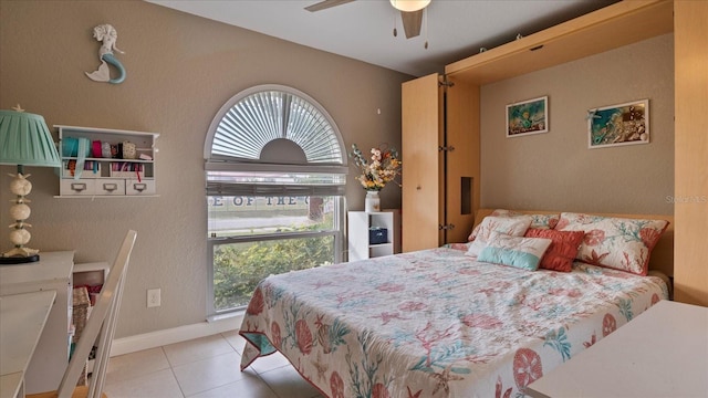 tiled bedroom with ceiling fan and multiple windows