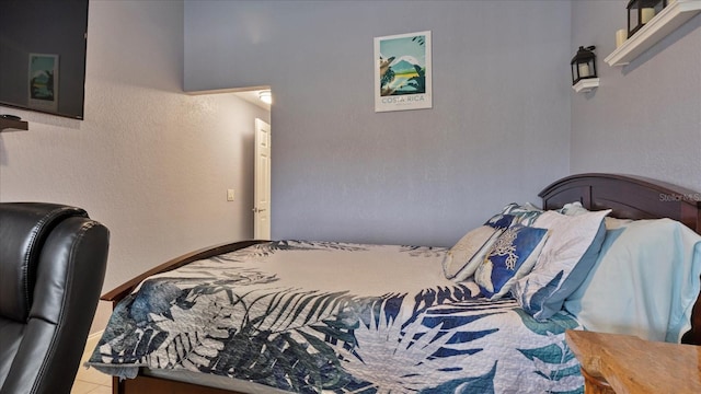 bedroom with light tile patterned floors