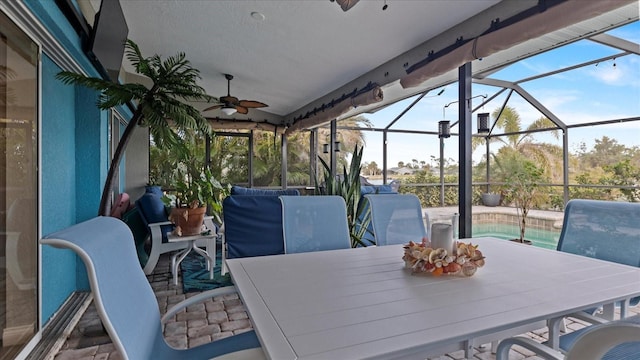 view of patio / terrace with ceiling fan and a lanai