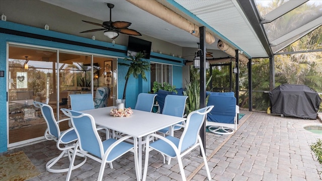 view of patio with a lanai, ceiling fan, and a grill