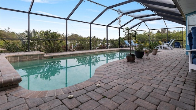 view of swimming pool featuring a lanai and a patio area