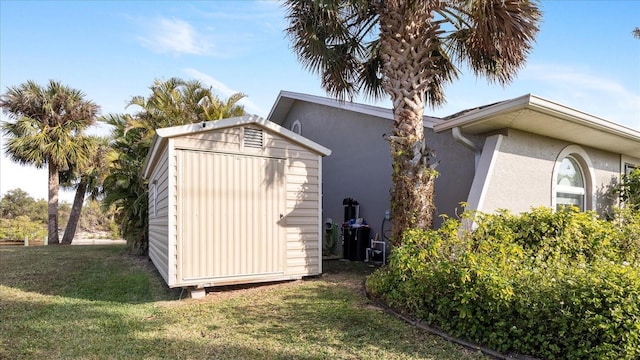 view of outbuilding with a yard