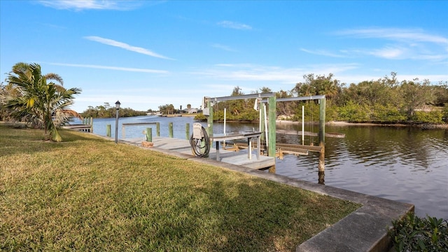 dock area with a yard and a water view