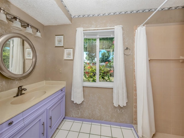 bathroom featuring tile patterned flooring, a textured ceiling, a shower with shower curtain, and vanity