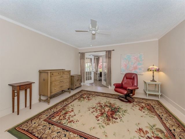 living area with a textured ceiling, ornamental molding, and ceiling fan