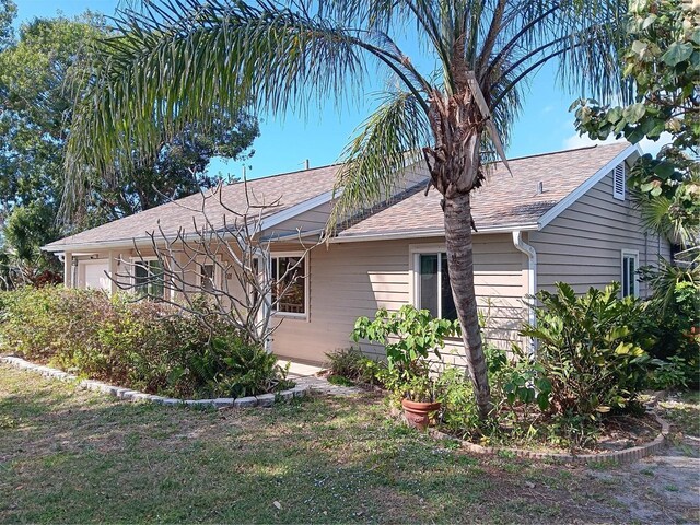 601 E Seminole Dr, Venice, FL 34293 - view of home's exterior with a garage and a lawn