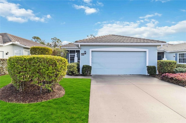 view of front facade with a garage and a front lawn