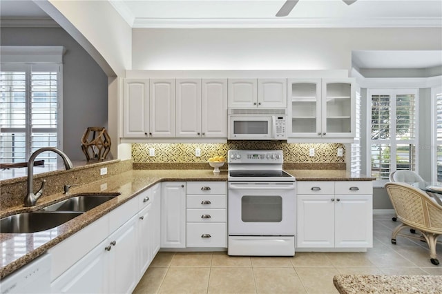 kitchen featuring white cabinetry, sink, and white appliances