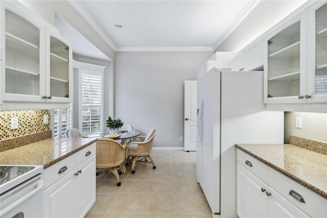 kitchen with backsplash, light stone countertops, light tile patterned floors, and white cabinets