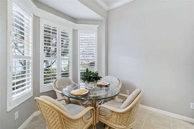 tiled dining space featuring crown molding and a wealth of natural light