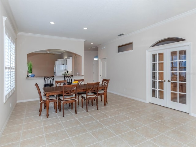 dining room featuring crown molding, french doors, and light tile patterned floors