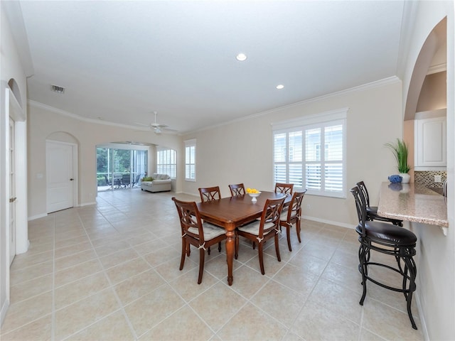 dining space featuring ornamental molding, ceiling fan, and light tile patterned flooring