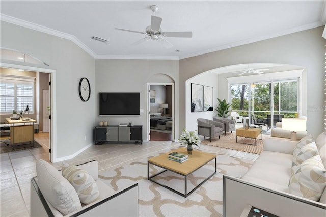 tiled living room featuring crown molding and ceiling fan