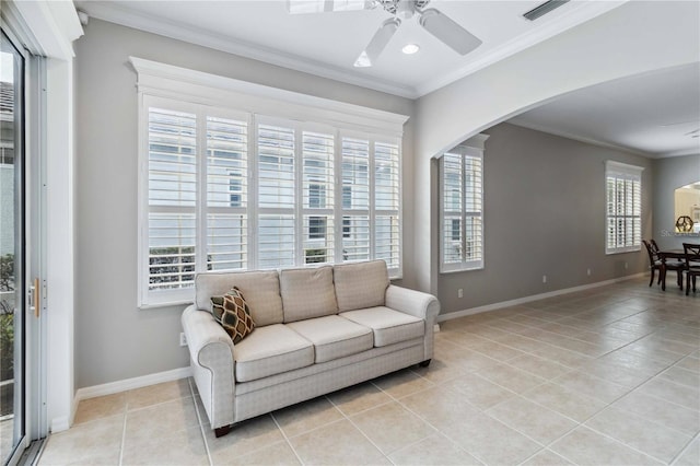 tiled living room featuring ornamental molding and ceiling fan