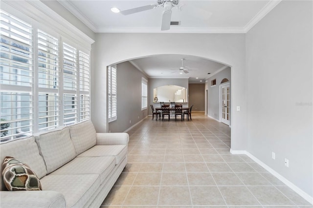 tiled living room with crown molding and ceiling fan