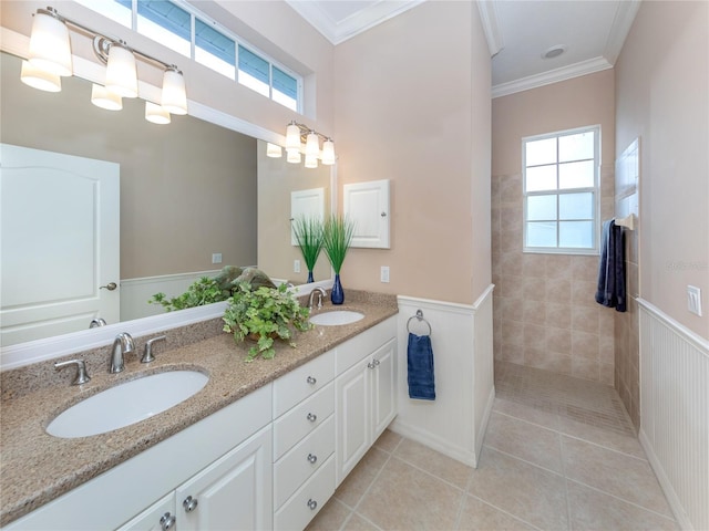 bathroom featuring vanity, ornamental molding, tile patterned floors, and a healthy amount of sunlight