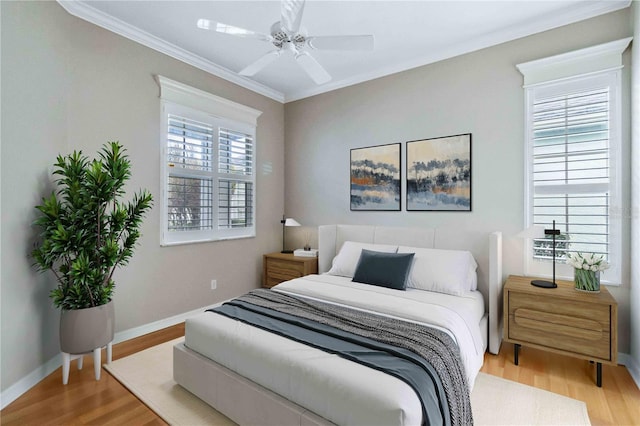 bedroom featuring multiple windows, wood-type flooring, and ceiling fan