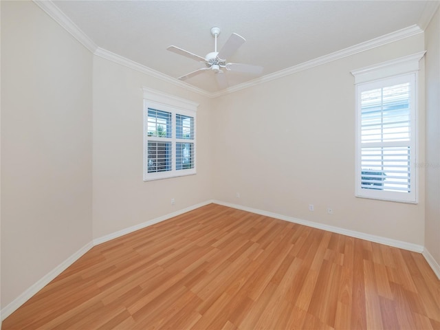 spare room featuring ceiling fan, ornamental molding, and light wood-type flooring