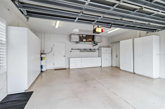 garage with a garage door opener and water heater