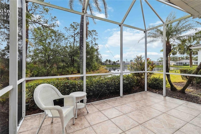 unfurnished sunroom with a water view