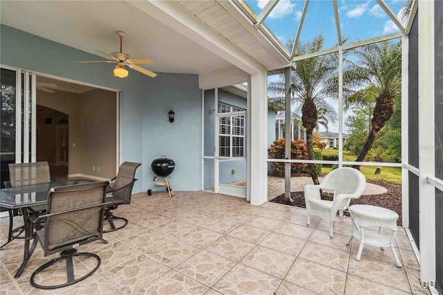 sunroom featuring ceiling fan and lofted ceiling