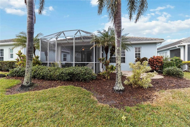 back of property featuring a yard and a lanai