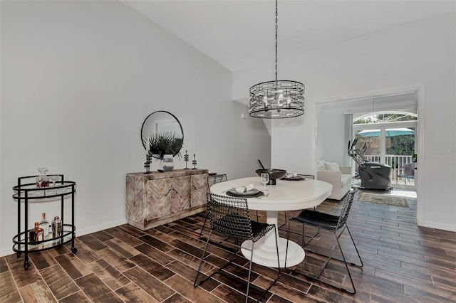 dining area featuring vaulted ceiling and a notable chandelier