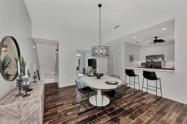 dining area with ceiling fan with notable chandelier