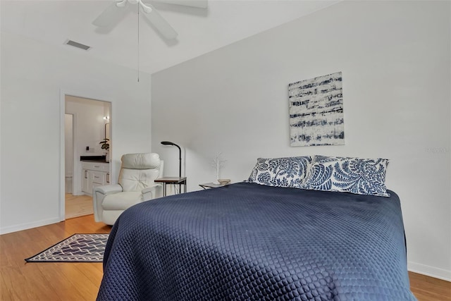 bedroom featuring ceiling fan, wood-type flooring, and connected bathroom