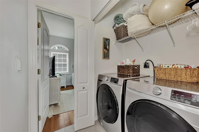 washroom featuring light wood-type flooring and washing machine and dryer