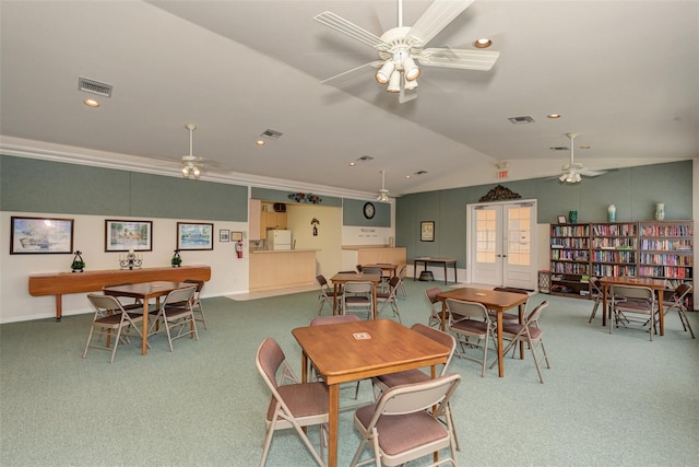 dining room with ornamental molding, lofted ceiling, and carpet flooring