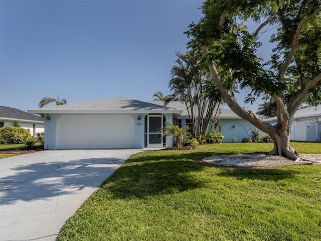 ranch-style home with a garage and a front lawn