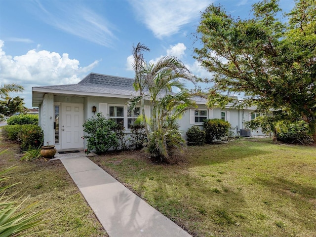 view of front of property with cooling unit and a front yard