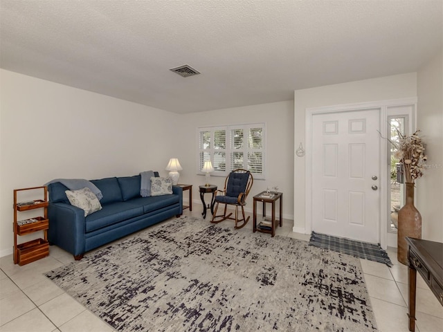 tiled living room with a textured ceiling