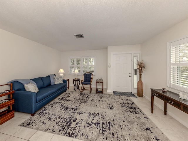 living room with light tile patterned floors and a textured ceiling