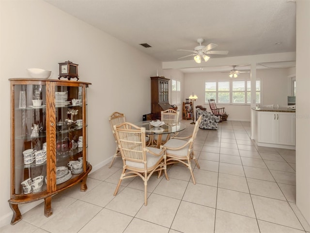 dining space with ceiling fan and light tile patterned floors