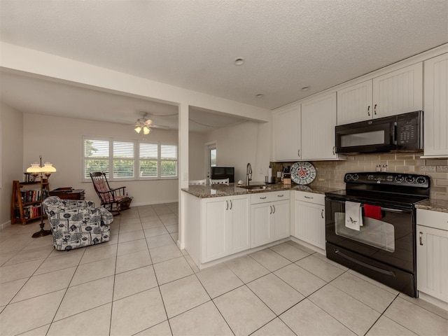 kitchen with dark stone counters, ceiling fan, sink, black appliances, and white cabinets