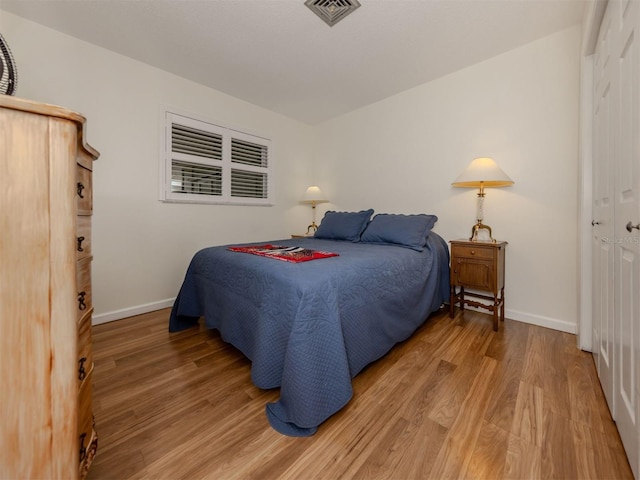 bedroom featuring hardwood / wood-style floors and a closet