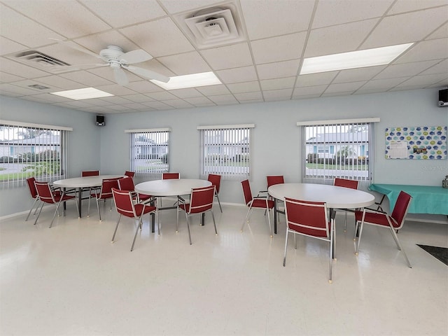 dining area with a paneled ceiling, plenty of natural light, and ceiling fan