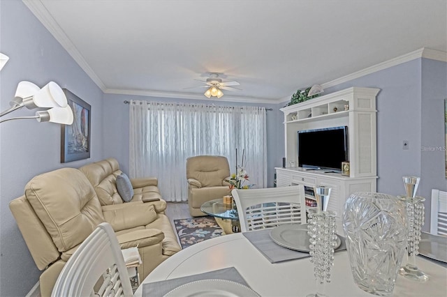 living room with ceiling fan and ornamental molding