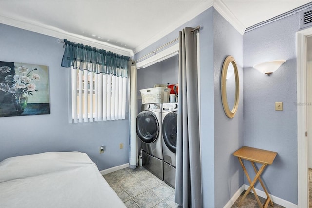 laundry area featuring ornamental molding and washer and clothes dryer