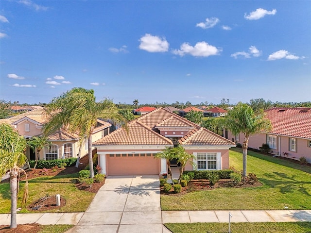 mediterranean / spanish-style house featuring a garage and a front yard