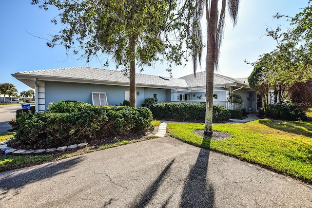 ranch-style home featuring a front yard